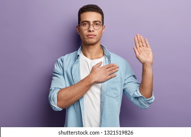 A man indicating that he is being completely honest