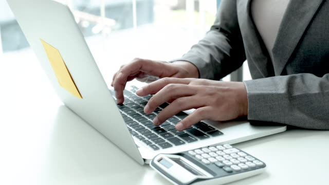 A professional person typing on a laptop, indicating the care of professionalism.